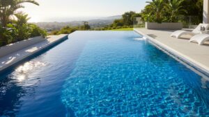 A pristine, modern swimming pool with a seamless blue polyurea coating reflecting the bright sun.